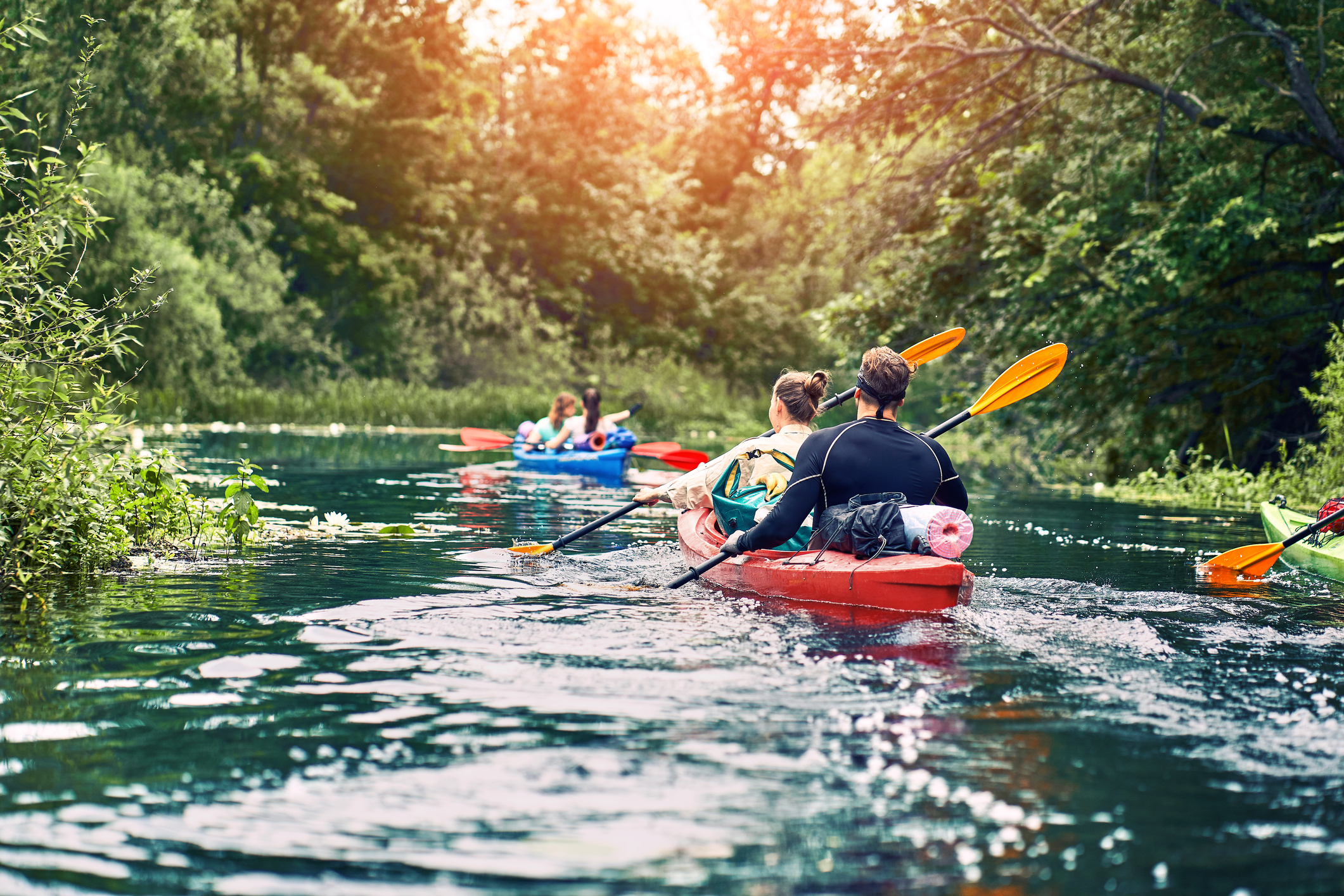 Happy best friends having fun on a kayaks Kayaking on the river